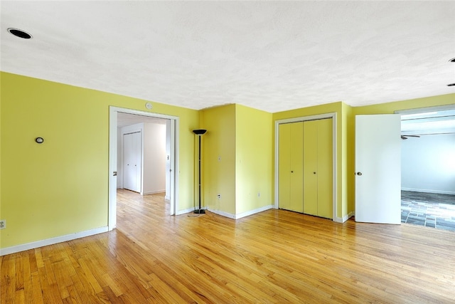 unfurnished bedroom featuring light hardwood / wood-style floors and a textured ceiling