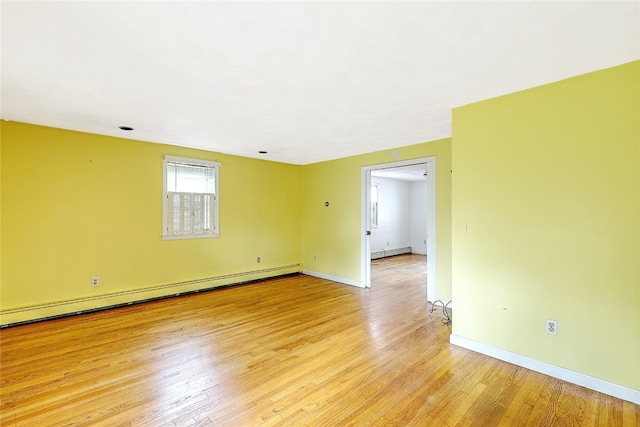 spare room with light hardwood / wood-style floors and a baseboard heating unit