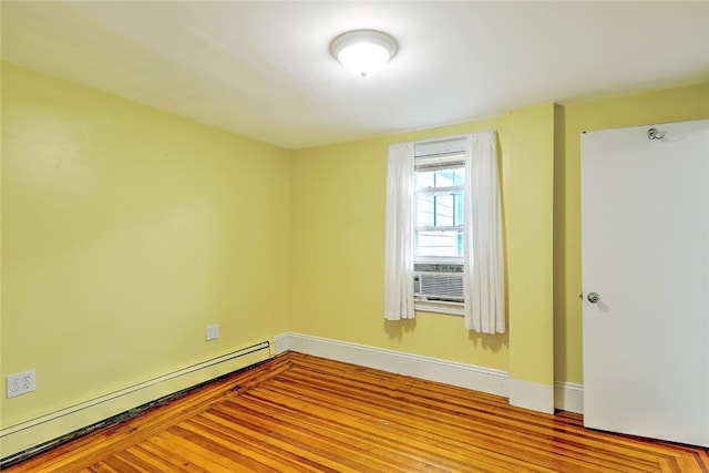 unfurnished room with baseboard heating, light hardwood / wood-style floors, and cooling unit