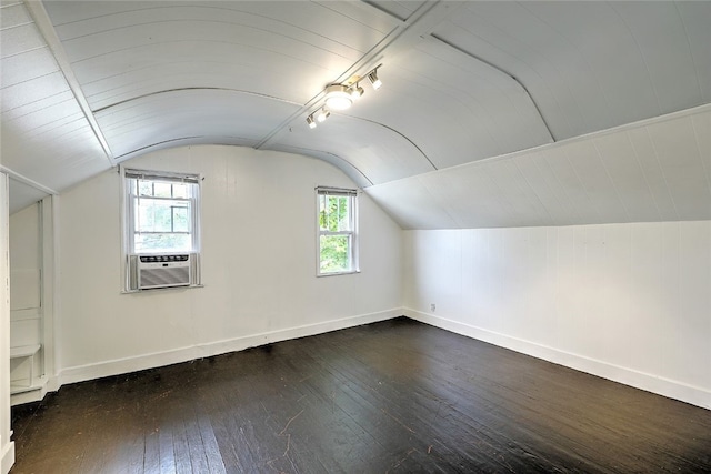 bonus room with dark wood-type flooring, cooling unit, and vaulted ceiling