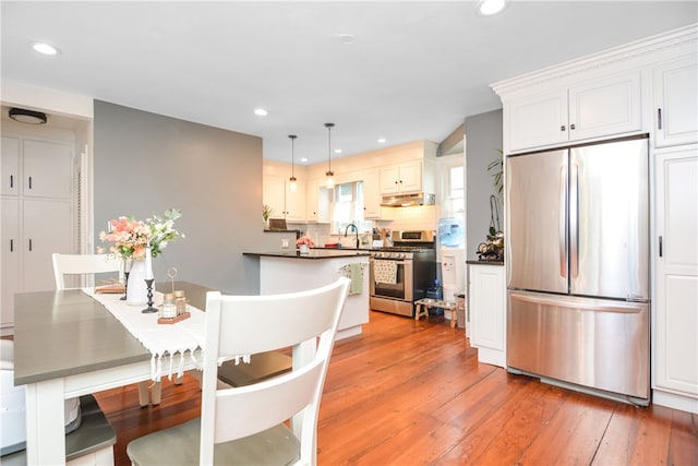 dining space featuring light hardwood / wood-style floors and sink