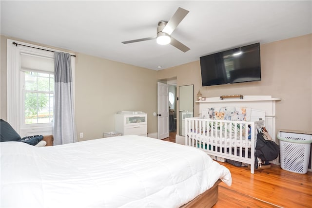 bedroom with hardwood / wood-style floors and ceiling fan