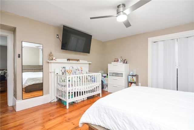 bedroom featuring hardwood / wood-style flooring, ceiling fan, and a closet