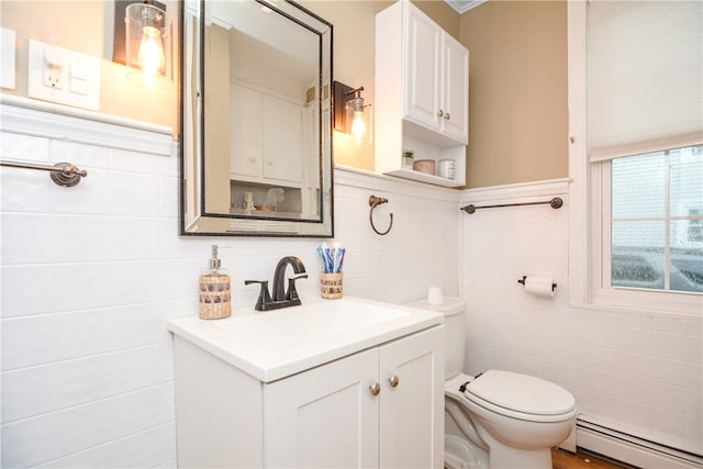 bathroom featuring baseboard heating, vanity, toilet, and tile walls