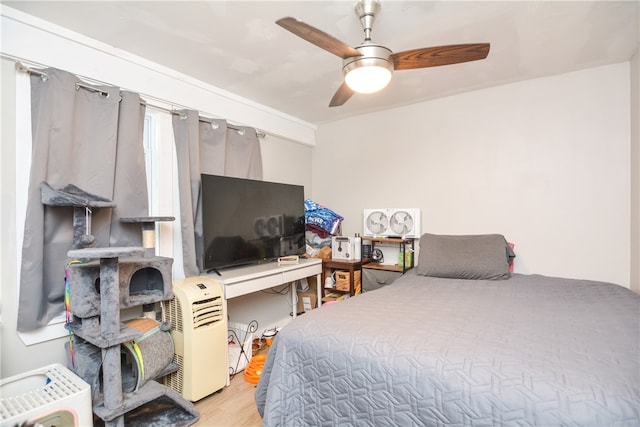 bedroom featuring light hardwood / wood-style floors and ceiling fan