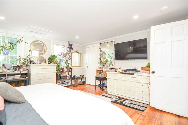 bedroom with wood-type flooring and ornamental molding