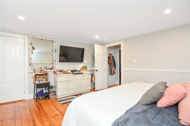 bedroom with hardwood / wood-style flooring and ornamental molding