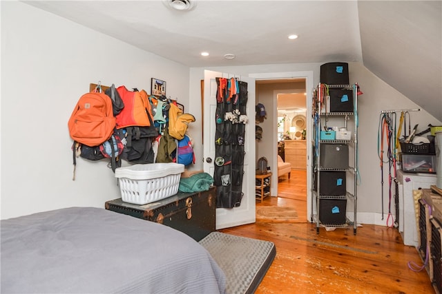 bedroom with wood-type flooring and lofted ceiling