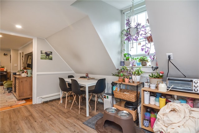 dining space with light wood-type flooring and vaulted ceiling