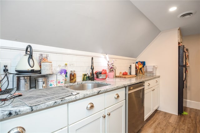 kitchen featuring sink, light hardwood / wood-style flooring, lofted ceiling, white cabinets, and dishwasher