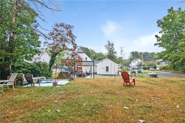 view of yard with a fire pit and a deck