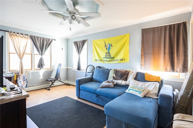 living room featuring a wealth of natural light, hardwood / wood-style floors, and baseboard heating