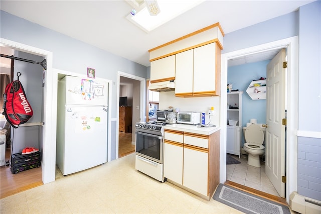 kitchen featuring a baseboard radiator, light hardwood / wood-style floors, range hood, white cabinets, and white appliances