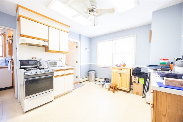 kitchen with ceiling fan, baseboard heating, and white range oven