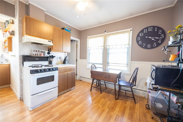 kitchen featuring ornamental molding, ceiling fan, light hardwood / wood-style flooring, a baseboard radiator, and white stove