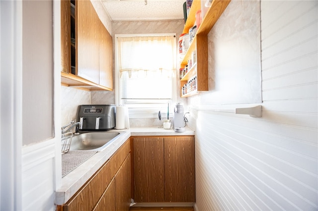 kitchen featuring sink and a textured ceiling