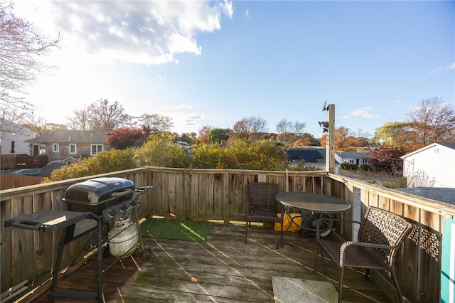 wooden deck featuring a grill