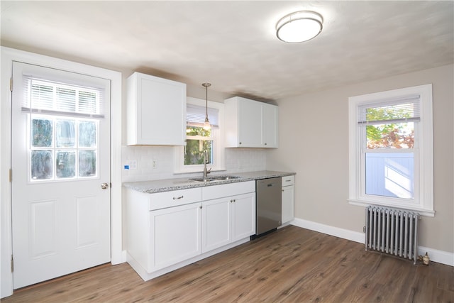 kitchen with radiator, hanging light fixtures, stainless steel dishwasher, dark hardwood / wood-style floors, and white cabinetry