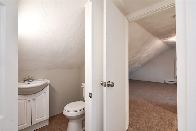 bathroom featuring vanity, tile patterned flooring, a baseboard radiator, toilet, and lofted ceiling