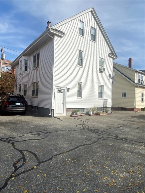 rear view of house with cooling unit