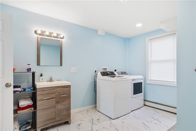 washroom featuring a baseboard radiator, sink, and washer and clothes dryer