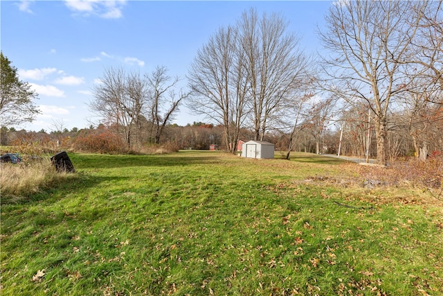 view of yard with a storage shed and a rural view