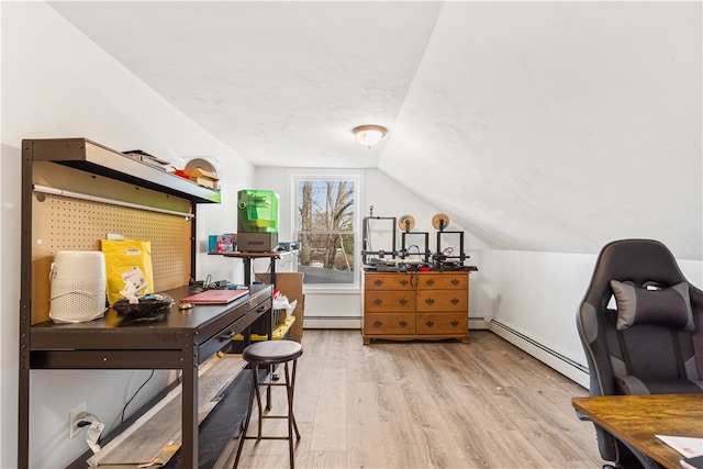 office space with light wood-type flooring, a baseboard radiator, and vaulted ceiling