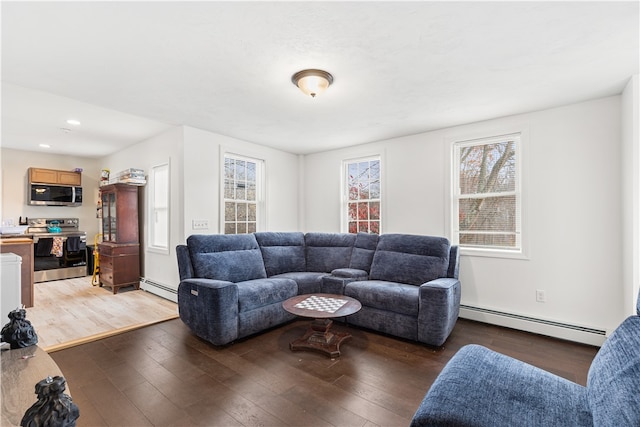 living room with dark wood-type flooring and baseboard heating