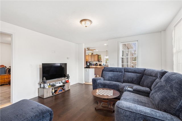 living room featuring dark hardwood / wood-style floors and ceiling fan