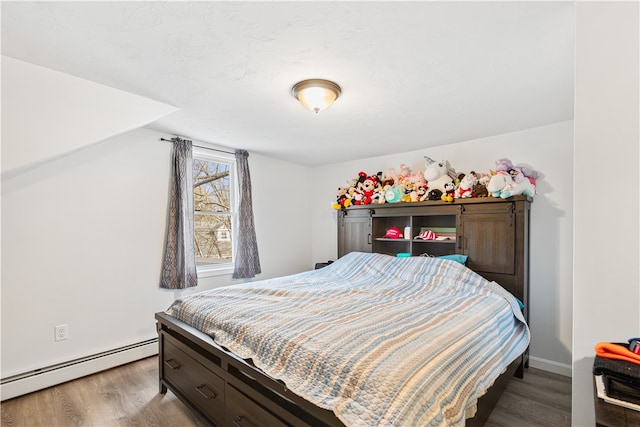 bedroom featuring wood-type flooring and baseboard heating