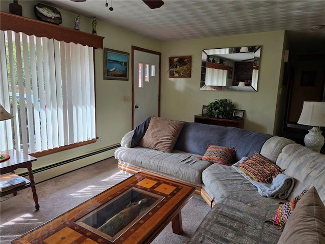 living room featuring ceiling fan, carpet floors, a textured ceiling, and a baseboard heating unit