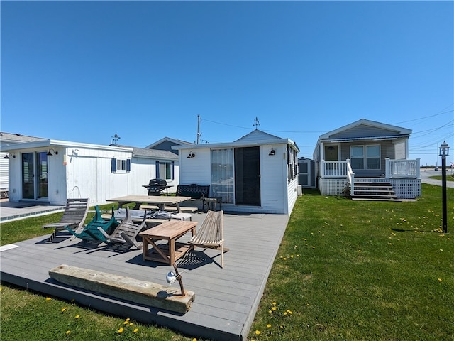 rear view of house with a yard and a wooden deck