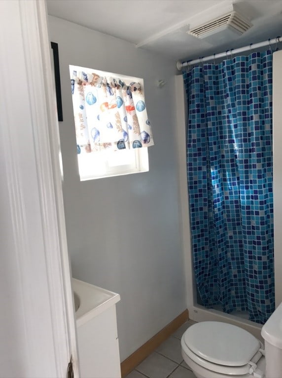 bathroom with tile patterned flooring, vanity, toilet, and a shower with curtain