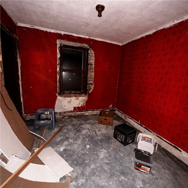 misc room featuring ornamental molding and a textured ceiling