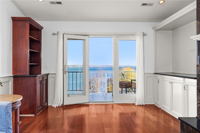 doorway to outside featuring a wealth of natural light, a water view, and dark hardwood / wood-style floors