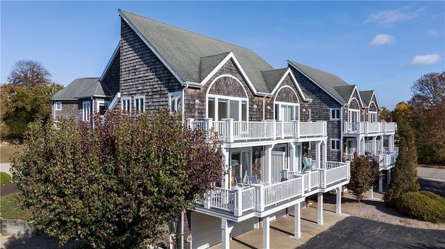 back of house featuring a balcony