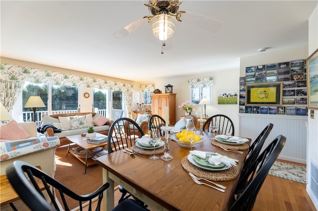 dining space with light hardwood / wood-style floors and ceiling fan