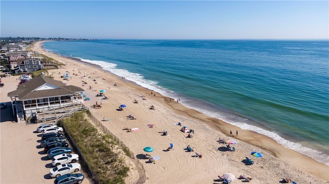 drone / aerial view featuring a beach view and a water view