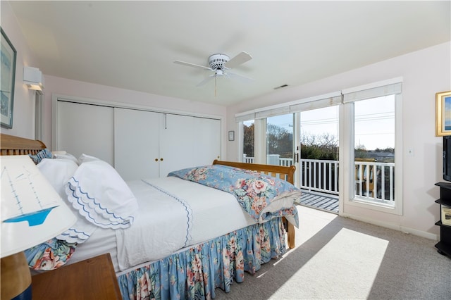 bedroom featuring a closet, light colored carpet, ceiling fan, and access to exterior