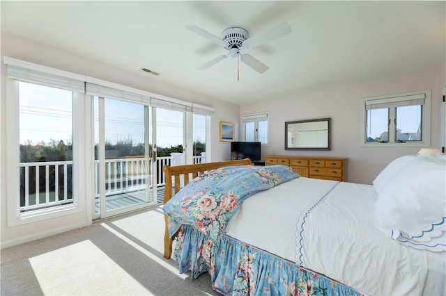 bedroom with access to outside, ceiling fan, and carpet