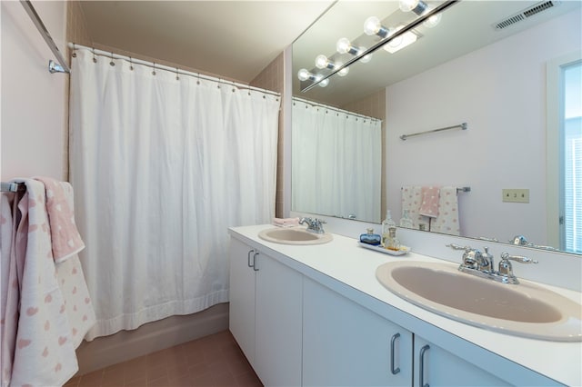 bathroom featuring shower / tub combo, vanity, and tile patterned floors