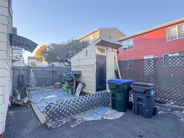 view of patio featuring a storage unit