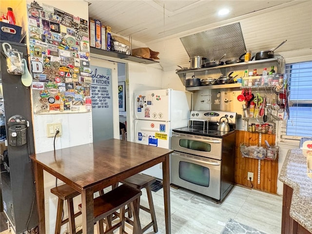 kitchen with fridge, electric stove, and white refrigerator