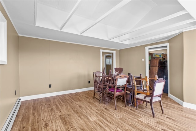 dining room with lofted ceiling, light wood-type flooring, and a baseboard heating unit