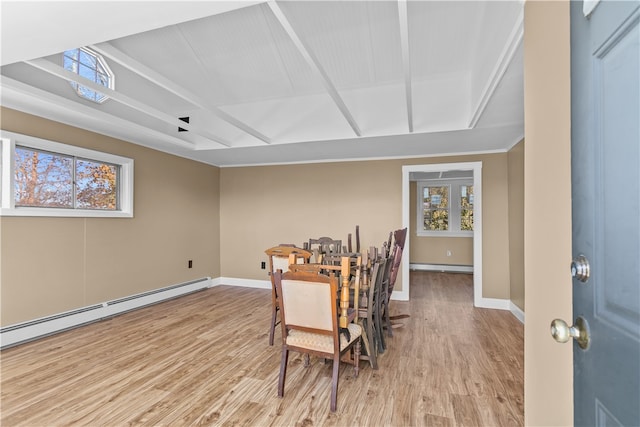 dining room featuring beam ceiling, light hardwood / wood-style floors, and a baseboard heating unit