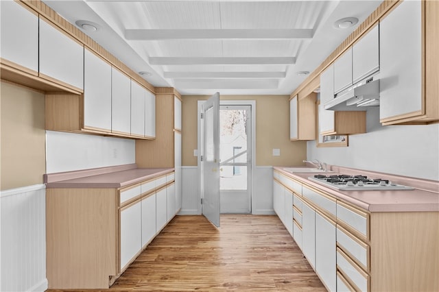 kitchen featuring white cabinets, sink, light hardwood / wood-style floors, and white gas stovetop