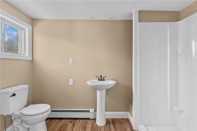 bathroom with toilet, a baseboard radiator, and hardwood / wood-style flooring