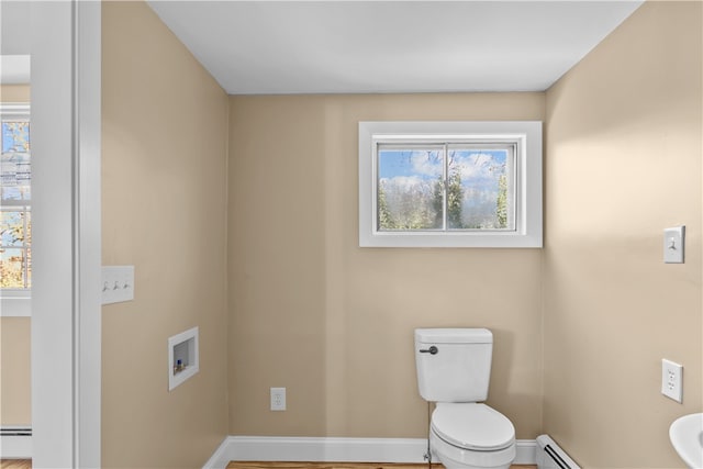 bathroom featuring a baseboard radiator and toilet