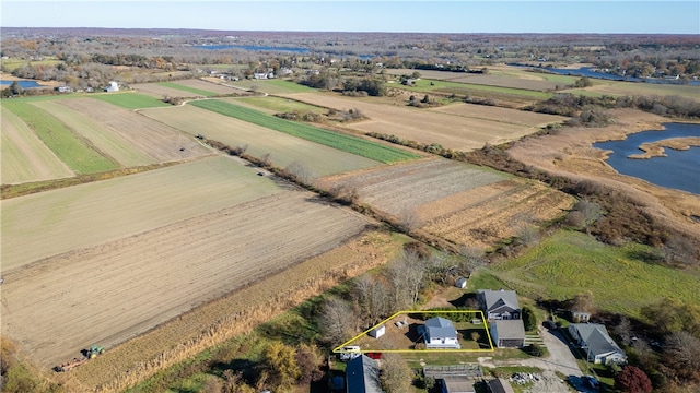 birds eye view of property featuring a water view and a rural view