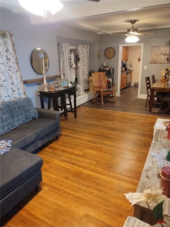 living room featuring ceiling fan and wood-type flooring